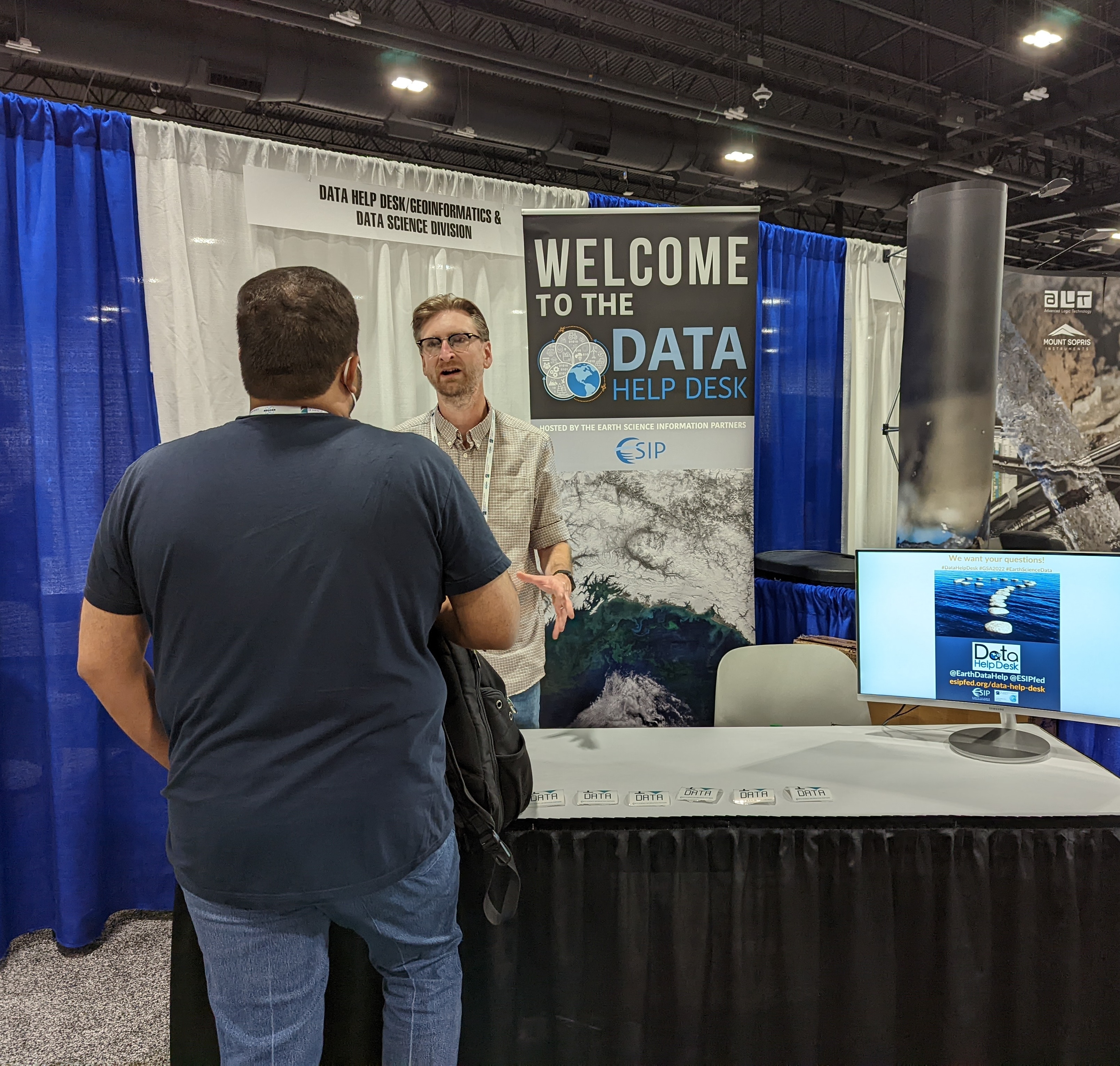 Data Help Desk table with volunteers interacting with users